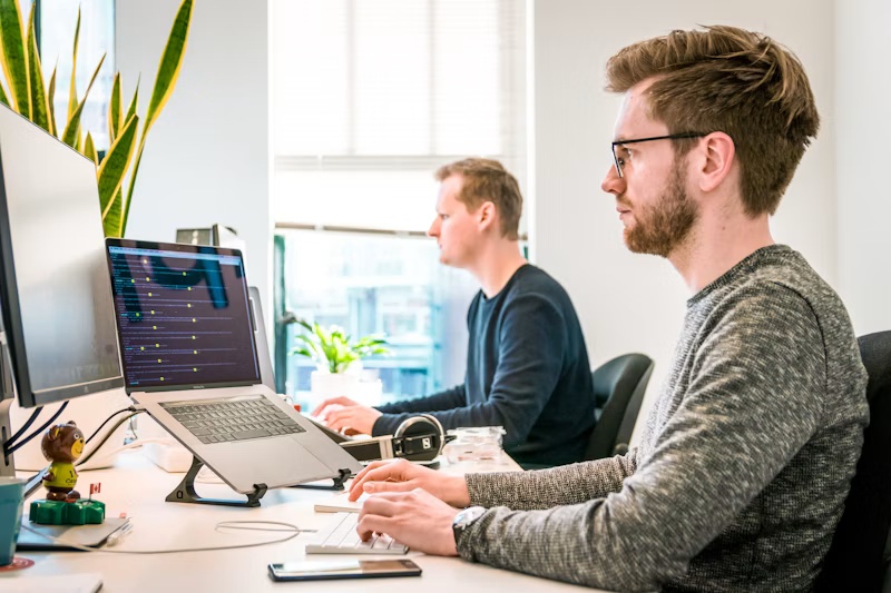 Digital business team working together at computers